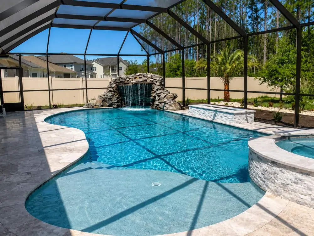Agua Pools Florida gallery, pool sun shelf, rock waterfall, screen enclosure.