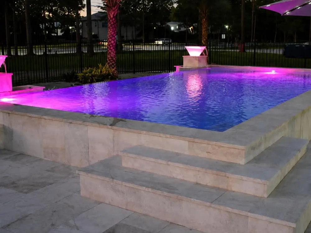 Agua Pools gallery pool at night with LED pool lighting