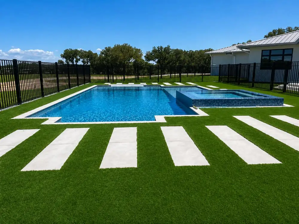 artificial turf, travertine deck around pool by Agua Pools, Ocala Pool Builder