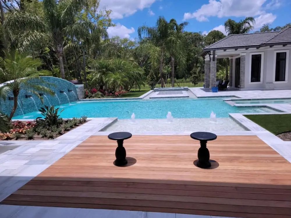 Holly Hill FL pool builder design with deck, raised wall, scuppers and water features