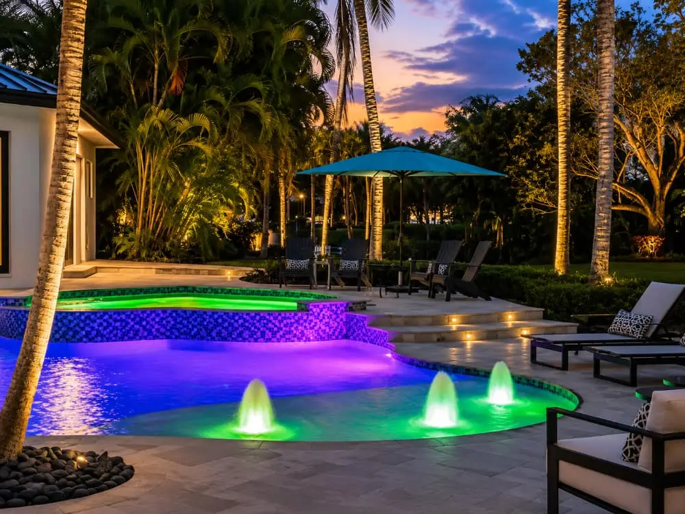 pool at night lit up with bright brilliant LED pool lights