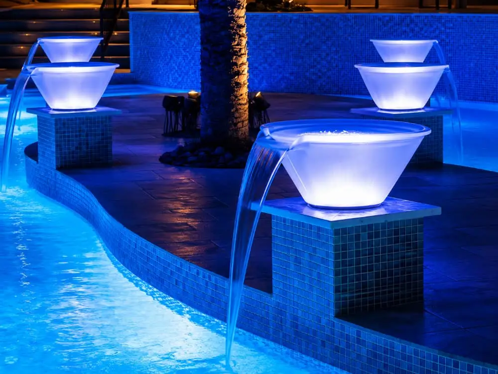 pool waterfall bowls lit up at night