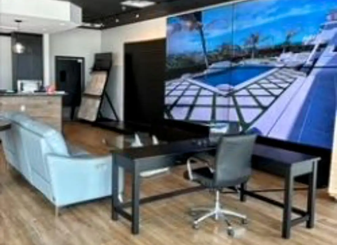 the interior of the Agua Pools FL Daytona Beach showroom with interactive screen and seating