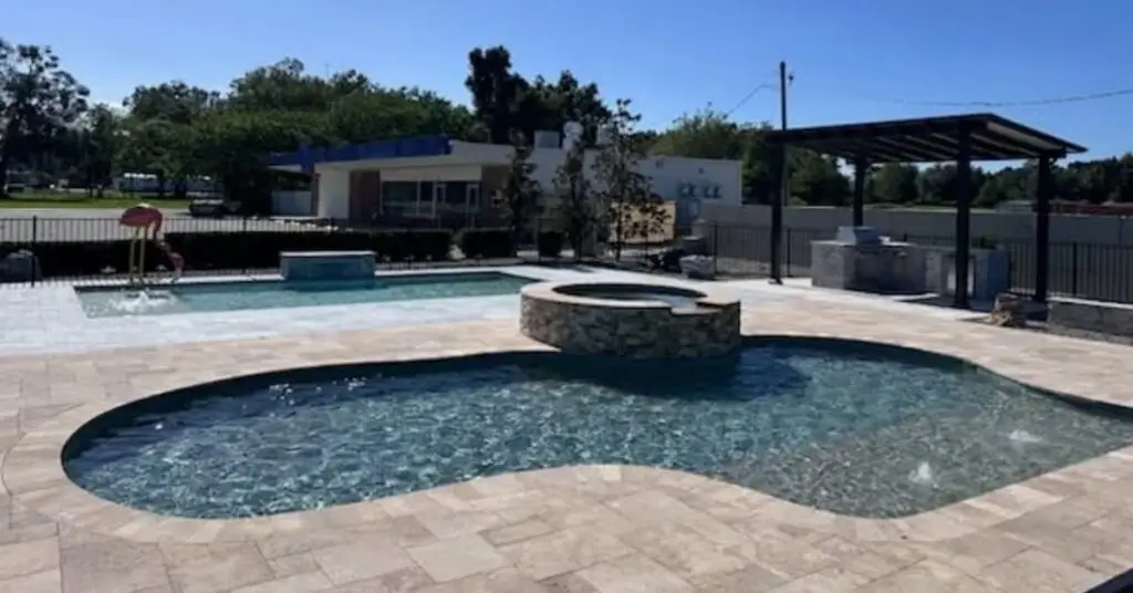 Agua Pools Ocala Florida Outdoor Pool display center showing geometric and freeform pool with spa, pergola and decking